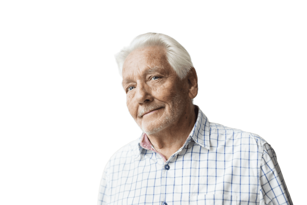Close-up portrait of an elderly man with white hair and a slight smile, wearing a checked shirt.